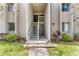 Condo entrance with stairs, well-maintained landscaping and unit number clearly displayed at 134 Springwood Cir # A, Longwood, FL 32750