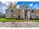 Exterior view of building featuring well-maintained lawn and paved parking at 134 Springwood Cir # A, Longwood, FL 32750