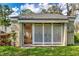 Charming pool house with lattice doors and a convenient entrance, perfect for poolside relaxation at 134 Springwood Cir # A, Longwood, FL 32750