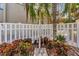 Outdoor shower with a white fence, surrounded by vibrant plants, providing a refreshing experience at 134 Springwood Cir # A, Longwood, FL 32750