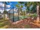 Community tennis court surrounded by mature trees and lush foliage at 134 Springwood Cir # A, Longwood, FL 32750