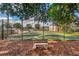 Community tennis court with a bench, offering a great space for recreation and outdoor activities at 134 Springwood Cir # A, Longwood, FL 32750