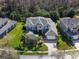 Beautifully landscaped home featuring a gray roof, lush lawn, and surrounded by mature trees in a quiet neighborhood at 16315 Bristol Lake Cir, Orlando, FL 32828