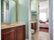 Bathroom featuring oak cabinets, tile floors, and neutral color palette at 16315 Bristol Lake Cir, Orlando, FL 32828