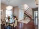 Elegant dining area featuring hardwood floors, a chandelier, and a view of the staircase and front entrance at 16315 Bristol Lake Cir, Orlando, FL 32828