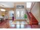 Grand foyer featuring hardwood floors, a staircase with iron railings, and a view into the adjacent dining room at 16315 Bristol Lake Cir, Orlando, FL 32828