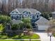 Beautiful two-story home with stone accents, lush landscaping, palm trees, and a three-car garage at 16315 Bristol Lake Cir, Orlando, FL 32828