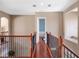 Hallway with wood floors and wrought iron banister on second floor at 16315 Bristol Lake Cir, Orlando, FL 32828