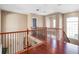 Upstairs hallway with hardwood floors and wrought iron railing at 16315 Bristol Lake Cir, Orlando, FL 32828