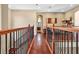 Hallway with wood floors and wrought iron banister on second floor at 16315 Bristol Lake Cir, Orlando, FL 32828