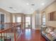 Upstairs living area featuring wood floors, couch and sunlit windows at 16315 Bristol Lake Cir, Orlando, FL 32828