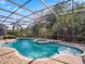 Relaxing screened-in pool area with brick pavers, hot tub, and lush landscaping, perfect for outdoor enjoyment at 16315 Bristol Lake Cir, Orlando, FL 32828