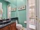 Stylish powder room with a granite countertop, decorative mirror, and elegant fixtures at 16315 Bristol Lake Cir, Orlando, FL 32828