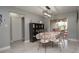 Bright dining room with decorative shelving, tiled floors, and sliding glass door access to the backyard at 1659 Nantucket St, Deltona, FL 32725