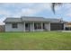 Charming single-story home with an airy front porch, large windows, and mature landscaping at 1659 Nantucket St, Deltona, FL 32725