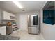 Spacious kitchen featuring stainless steel refrigerator, adjacent shelving, and an eat in kitchen area at 1659 Nantucket St, Deltona, FL 32725