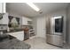 Modern kitchen featuring stainless steel refrigerator and granite countertops and white cabinetry at 1659 Nantucket St, Deltona, FL 32725