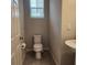 Small bathroom with a pedestal sink and window at 1820 Shumard Ave, St Cloud, FL 34771