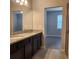 Bright bathroom featuring a double sink vanity with granite countertop and a view into the bedroom at 1820 Shumard Ave, St Cloud, FL 34771