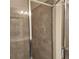 Tiled shower with a glass enclosure and modern fixtures at 1820 Shumard Ave, St Cloud, FL 34771