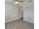 Light-filled bedroom with wood-look floors, neutral paint, and ceiling fan at 1820 Shumard Ave, St Cloud, FL 34771