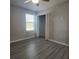 This bedroom features gray walls, wood-look flooring, and a ceiling fan at 1820 Shumard Ave, St Cloud, FL 34771