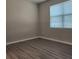 Simple bedroom with laminate flooring, a bright window, and neutral walls providing a clean and inviting space at 1820 Shumard Ave, St Cloud, FL 34771