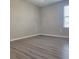 Empty bedroom with wood-look floors and a window at 1820 Shumard Ave, St Cloud, FL 34771