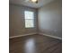 Bedroom with neutral walls, a window, and wood-look flooring at 1820 Shumard Ave, St Cloud, FL 34771