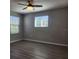 This bedroom features gray walls, wood-look flooring, and a ceiling fan at 1820 Shumard Ave, St Cloud, FL 34771