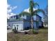 Exterior elevation view of the home showcasing the two-car garage and landscaping at 1820 Shumard Ave, St Cloud, FL 34771