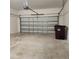 Spacious two car garage with a gray concrete floor and off white walls at 1820 Shumard Ave, St Cloud, FL 34771