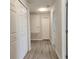 Inviting hallway with durable wood-look flooring and multiple storage closets at 1820 Shumard Ave, St Cloud, FL 34771