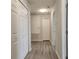 Inviting hallway with durable wood-look flooring and multiple storage closets at 1820 Shumard Ave, St Cloud, FL 34771