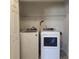 Bright laundry room with a side-by-side washer and dryer, plus a wire shelf for extra storage at 1820 Shumard Ave, St Cloud, FL 34771