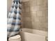 The shower features a blue and white shower curtain at 1820 Shumard Ave, St Cloud, FL 34771