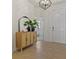 Foyer with tile flooring, a decorative cabinet with mirror, and modern light fixture at 1942 Rankin St, Kissimmee, FL 34744