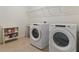 Functional laundry room with modern washer and dryer, and shelving for organization at 1942 Rankin St, Kissimmee, FL 34744