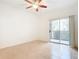 Bright bedroom with tile floors and sliding glass door to balcony at 2015 Erving Cir # 106, Ocoee, FL 34761