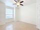 Bright bedroom with ceiling fan and large window at 2015 Erving Cir # 106, Ocoee, FL 34761