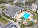 Community pool and hot tub with surrounding lounge chairs at 2015 Erving Cir # 106, Ocoee, FL 34761