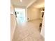 The foyer of the house features tile flooring and an open floor plan with views into the dining and living room at 2401 Begonia St, Mascotte, FL 34753