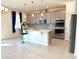 An eat-in kitchen features gray cabinets, stainless steel appliances, and pendant lighting at 2401 Begonia St, Mascotte, FL 34753