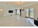 Bright living room featuring tiled floors, recessed lights, and a door to the backyard at 2401 Begonia St, Mascotte, FL 34753