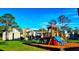 Community playground with a slide set and view of the apartments at 243 Scottsdale Sq # 243, Winter Park, FL 32792