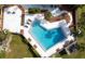 Aerial view of a community pool with a concrete deck and lounge chairs at 243 Scottsdale Sq # 243, Winter Park, FL 32792