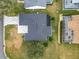 Overhead view of a home's roof, patio, and surrounding landscaping, showcasing the property's layout at 2488 Cherokee Ct, The Villages, FL 32162