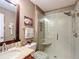 Bathroom showcasing a glass shower, granite countertop, and tiled floors at 2488 Cherokee Ct, The Villages, FL 32162