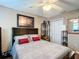 Comfortable bedroom featuring a decorative ceiling fan and a stylish upholstered headboard at 2488 Cherokee Ct, The Villages, FL 32162