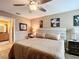 Well-lit bedroom with hardwood floors, a ceiling fan, and access to the bathroom at 2488 Cherokee Ct, The Villages, FL 32162